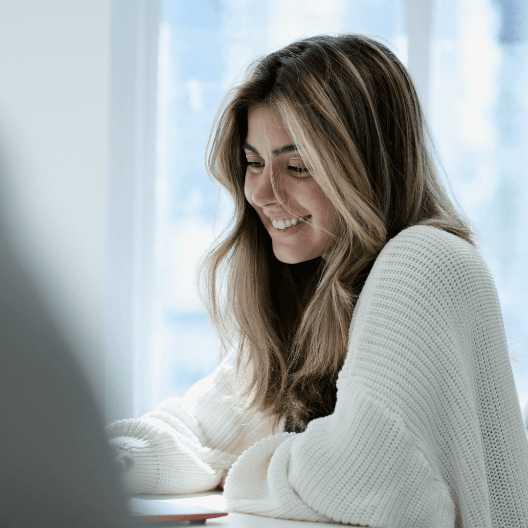 Beautiful Woman typing, smiling for photo